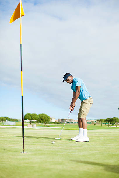 istock African golfer taking his last putt. 486553195