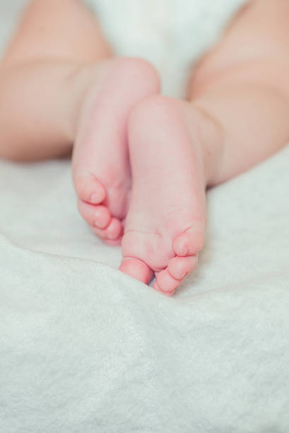 istock Feet small baby on a bed 486554436