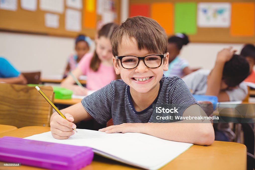 Little boy working at his desk in class Little boy working at his desk in class at the elementary school Child Stock Photo