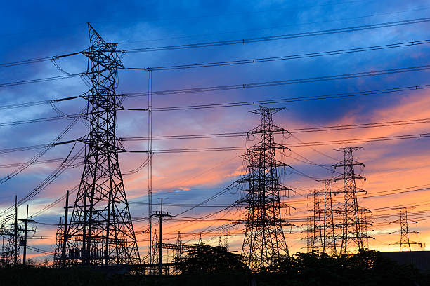 istock Silhouette power transmission tower  during twilight time 486555908