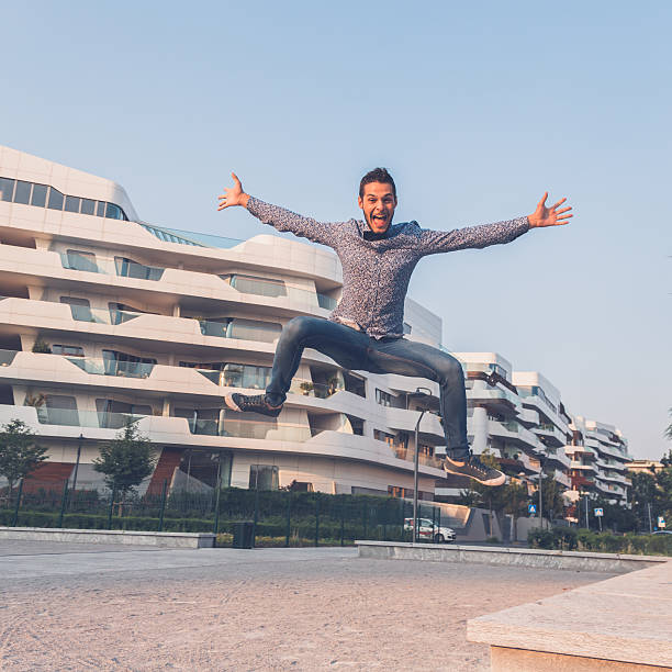 istock Young handsome man jumping in the city streets 486556824