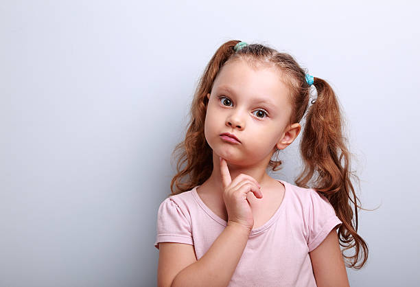 istock Fun confused kid girl thinking and looking serious about 486559862