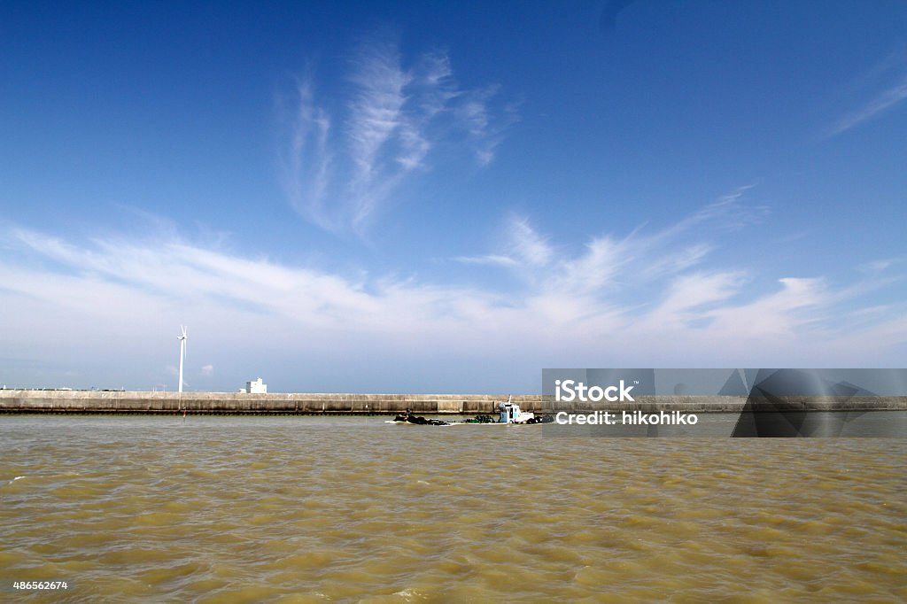 Small tanker sails the Tonegawa The shooting location is Choshi Port in Chiba Prefecture. The season is early summer. I felt that the contrast between the water surface muddy by rain and the blue sky was interesting and I took a picture. 2015 Stock Photo