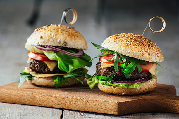 istock Delicious burgers with beef, tomato, cheese and lettuce 486564086