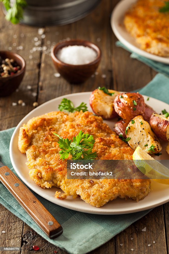 Homemade Breaded German Weiner Schnitzel Homemade Breaded German Weiner Schnitzel with Potatoes Wiener Schnitzel Stock Photo