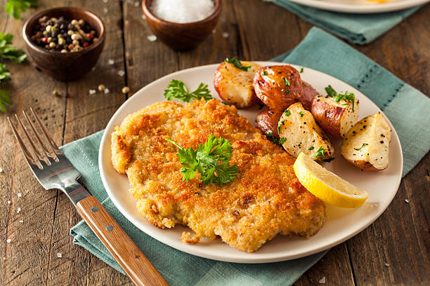 Homemade Breaded German Weiner Schnitzel Homemade Breaded German Weiner Schnitzel with Potatoes breaded photos stock pictures, royalty-free photos & images