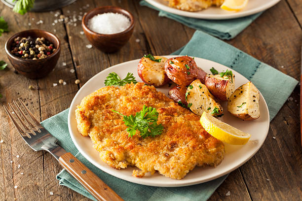Homemade Breaded German Weiner Schnitzel Homemade Breaded German Weiner Schnitzel with Potatoes german culture stock pictures, royalty-free photos & images