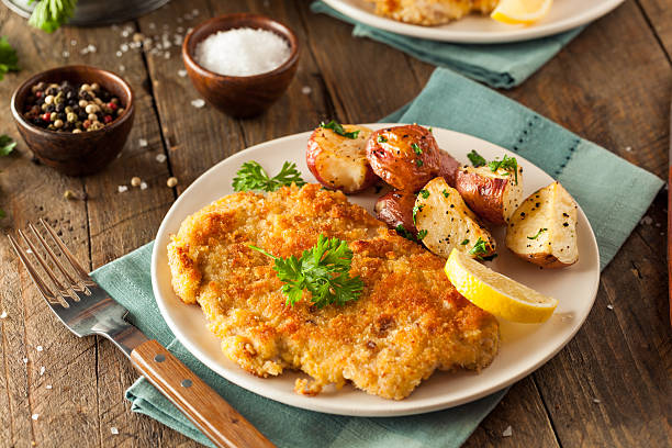 Homemade Breaded German Weiner Schnitzel Homemade Breaded German Weiner Schnitzel with Potatoes schnitzel stock pictures, royalty-free photos & images