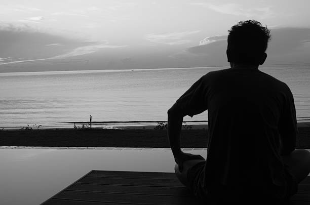 istock Lonely man blur beside the beach in black and white 486566290