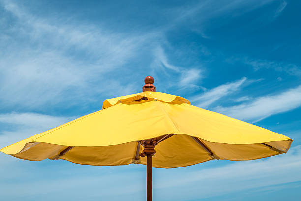 istock blue sky with soft cloud and yellow umbrella 486566404