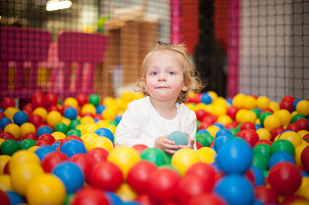 istock Baby girl in ball pool 486567159