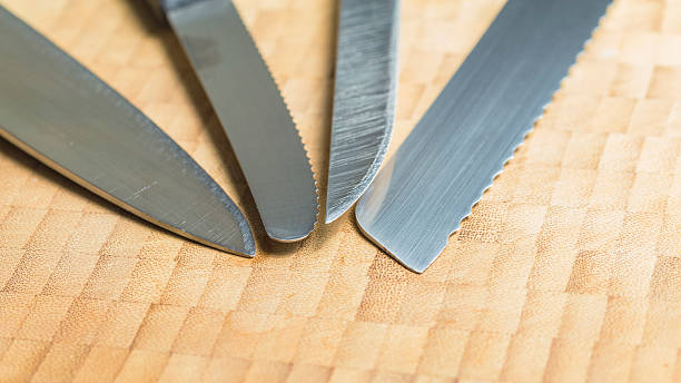 istock Used knives edge on a wooden background 486567990