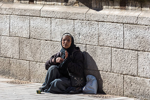 Hand of people giving bread or food to the homeless man