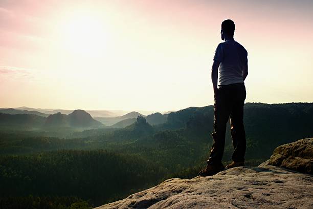 istock Satisfy tall hiker in shirt and trousers.Tall man on peak 486568512