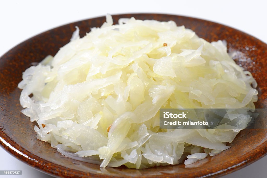 sauerkraut detail of sauerkraut on brown plate Brown Stock Photo