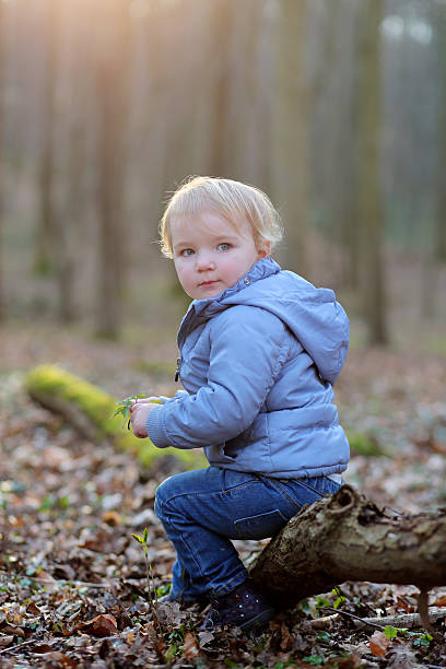 istock Happy toddler girl playing in summer or spring forest 486571017