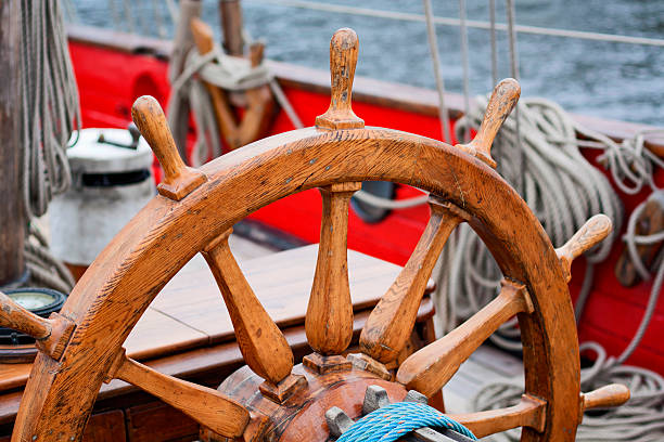 istock Sailing ship old wooden steering wheel 486571271