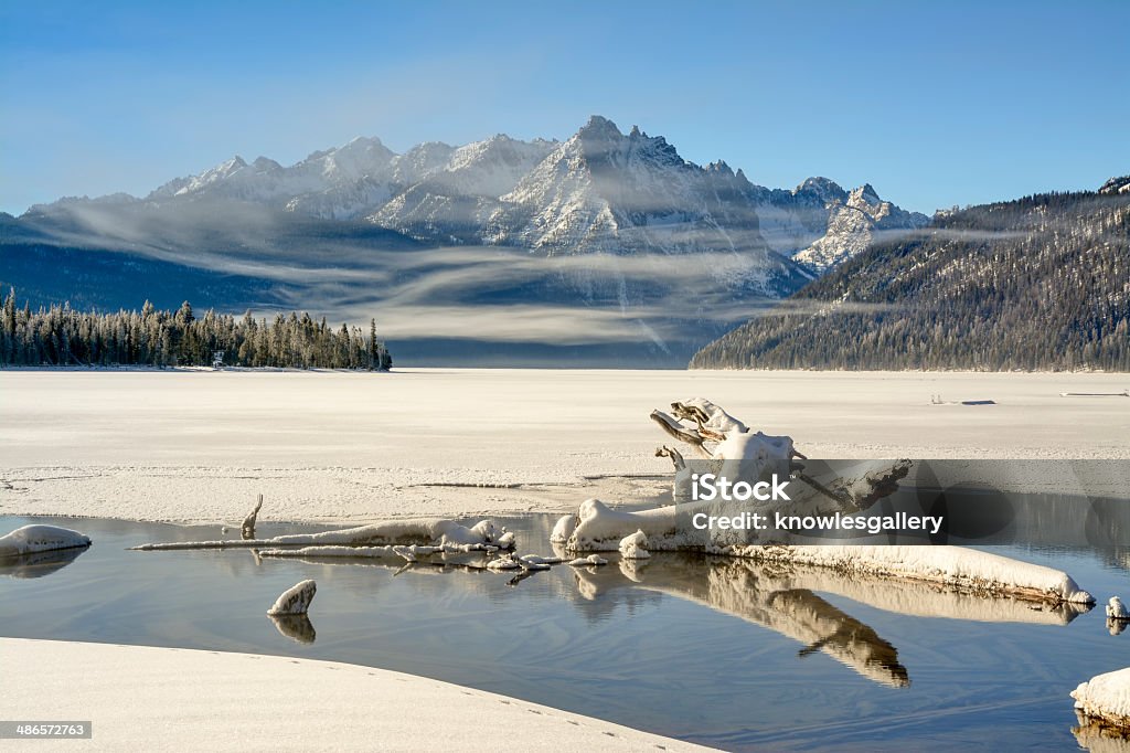 Beautiful winter snow covered lake Clearing fog on a winter lake in Idaho Cloud - Sky Stock Photo