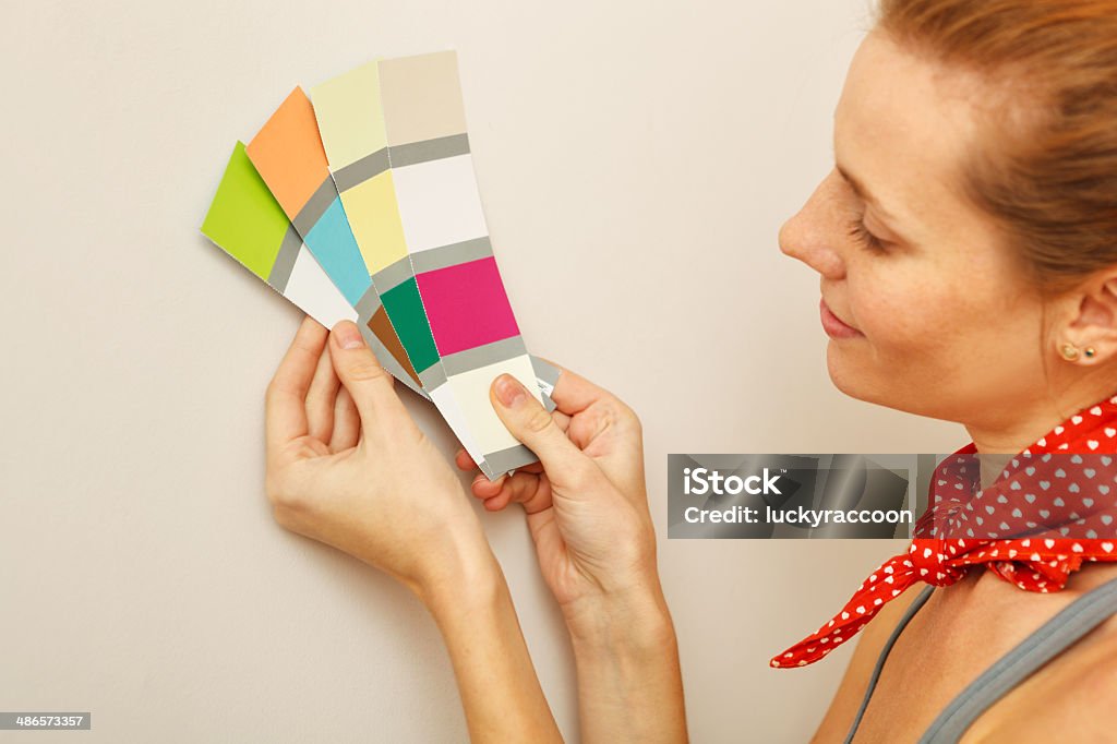Young beautiful woman holding color palette. Young beautiful woman holding color palette with color samples. Adult Stock Photo
