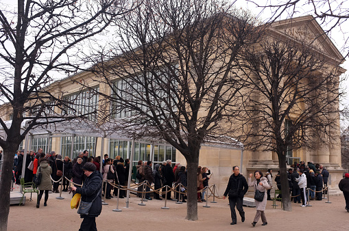 Paris, France- December 24, 2013: Visitors queue up for Frida Kahlo and Diego Rivera exhibition outside of Musée de l’Orangerie in Paris.
