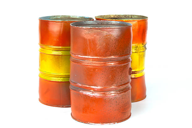 istock Old red & yellow oil barrels isolated on white background 486575368