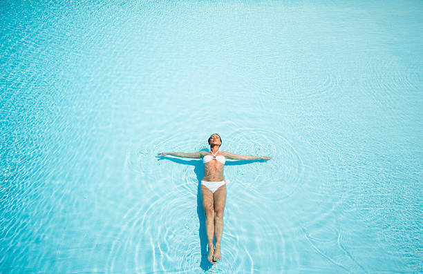 istock Young woman in the pool 486576532