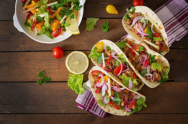 istock Mexican tacos with meat, beans and salsa 486577706