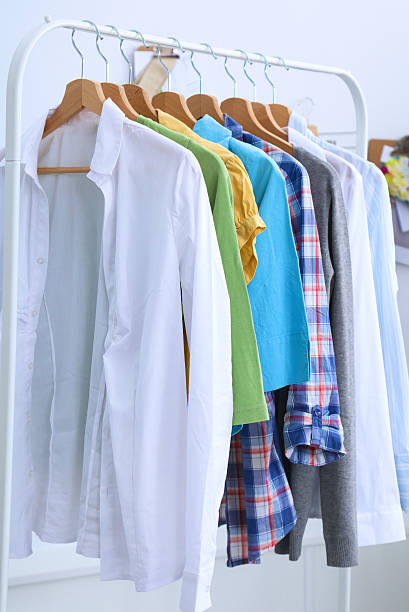 istock Clothes hang on a shelf in designer clothes store 486579290