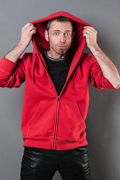 istock funny 40s man being silly with hoodie on 486580100