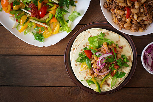 istock Mexican tacos with meat, beans and salsa 486580238