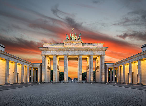 Brandenburg Gate at sunset, Berlin, Germany Panoramic view of famous Brandenburger Tor (Brandenburg Gate), one of the best-known landmarks and national symbols of Germany, in beautiful golden evening light at sunset, Pariser Platz, Berlin, Germany. east berlin photos stock pictures, royalty-free photos & images