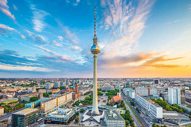 Berlin skyline panorama with TV tower at sunset, Germany Berlin skyline panorama with famous TV tower at Alexanderplatz and dramatic cloudscape at sunset, Germany. image created 21st century blue architecture wide angle lens stock pictures, royalty-free photos & images