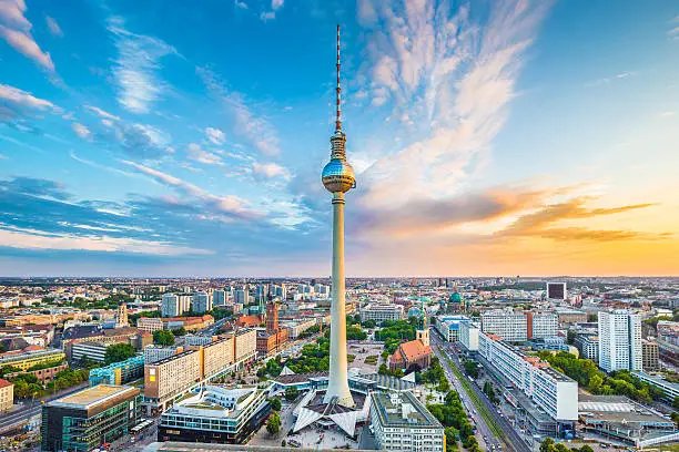 Berlin skyline panorama with famous TV tower at Alexanderplatz and dramatic cloudscape at sunset, Germany.