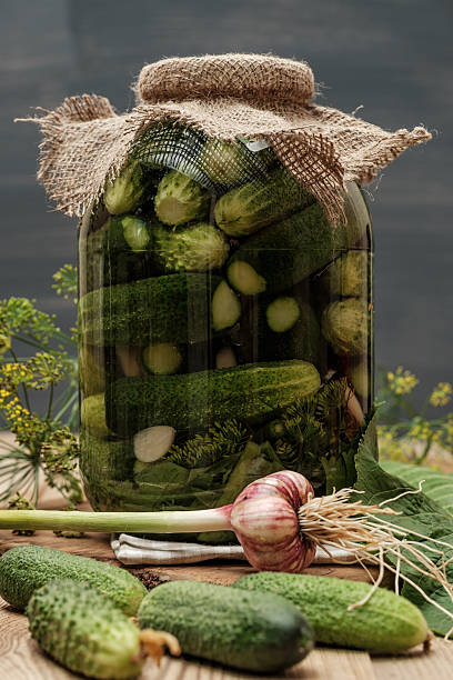 istock Jar of pickles on wooden table 486580786
