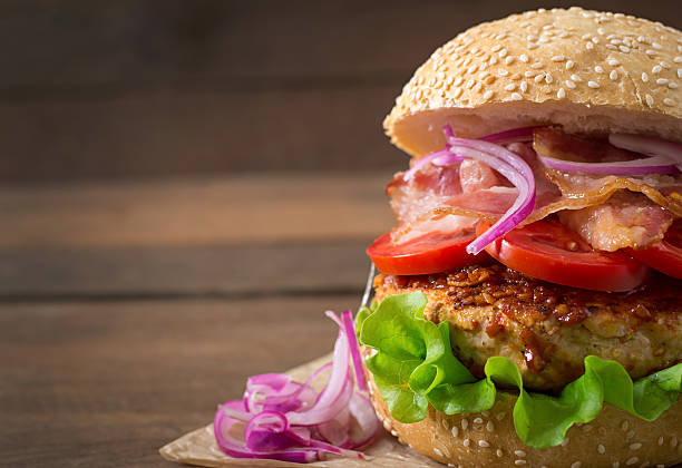istock Big sandwich - hamburger burger with beef, red onion, tomato. 486583316