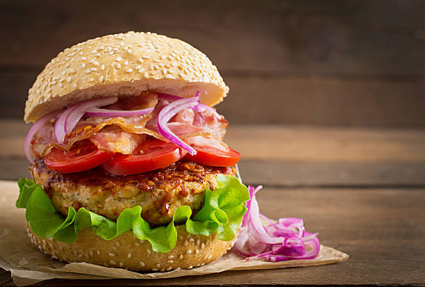 istock Big sandwich - hamburger burger with beef, red onion, tomato. 486583714
