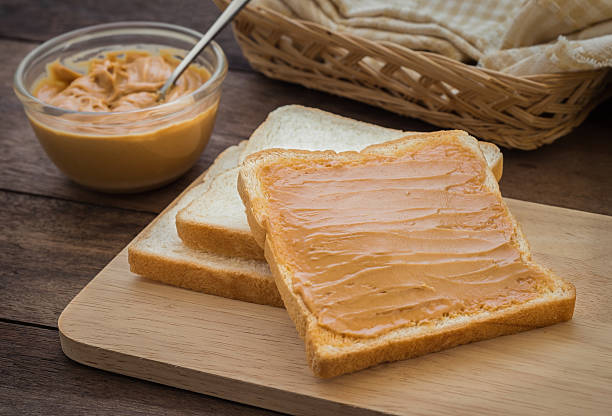 istock Peanut butter sandwich on wooden plate 486584596