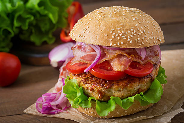 istock Big sandwich - hamburger burger with beef, red onion, tomato. 486584898