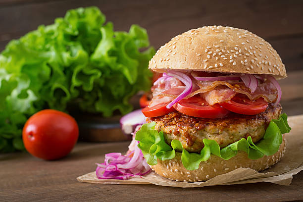istock Big sandwich - hamburger burger with beef, red onion, tomato. 486585032