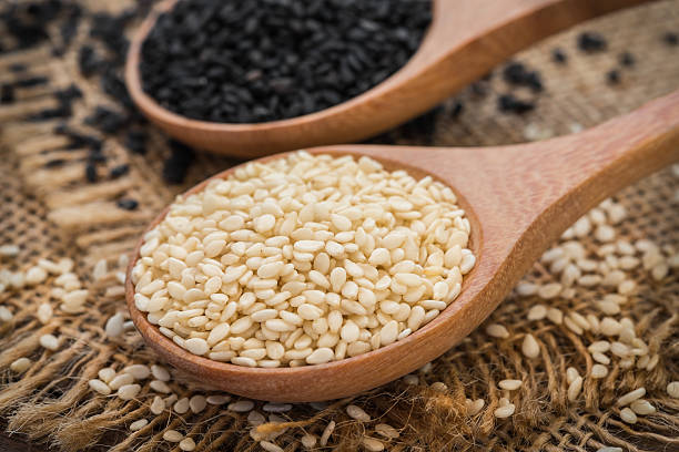 istock White sesame and black sesame seed on wooden spoon 486585066