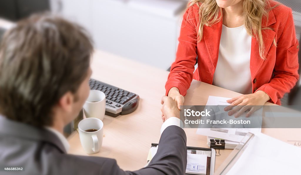 Agreement Male and female business people shaking hands Bonding Stock Photo