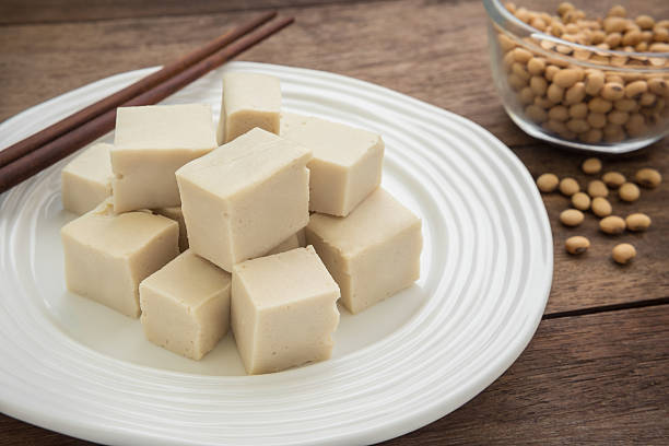 istock Tofu cubes on plate and soy beans in bowl 486585368