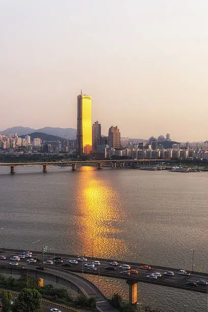 63 building in yeouido, seoul, south korea, reflecting the sunset light on the han river.