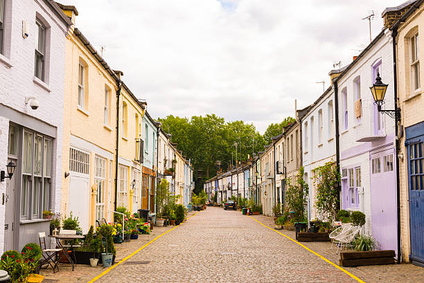 Exclusive mews with colored small houses in Chelsea London, UK - 1 August 2015: Exclusive mews with colored small houses in Chelsea, a  wealthy borough of London house uk row house london england stock pictures, royalty-free photos & images