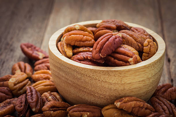 istock Pecan nuts in wooden bowl 486585606