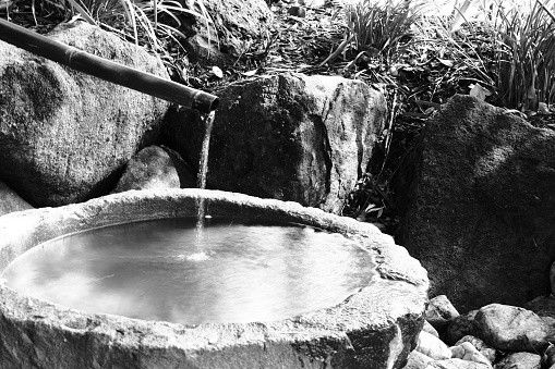 A shishi-odoshi breaks the quietness of a Japanese garden with the sound of a bamboo rocker ... Sōzu is a type of water fountain used in Japanese gardens.