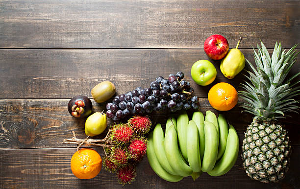 istock Fresh various fruits on wooden background. 486587978