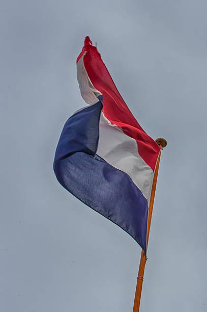 istock Flag of Netherlands flying against a blue sky. 486588668