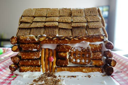 Log Cabin Gingerbread House Made from Cereal and Pretzels 