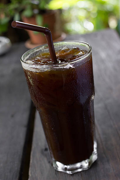 istock Ice black coffee on wooden table 486589156